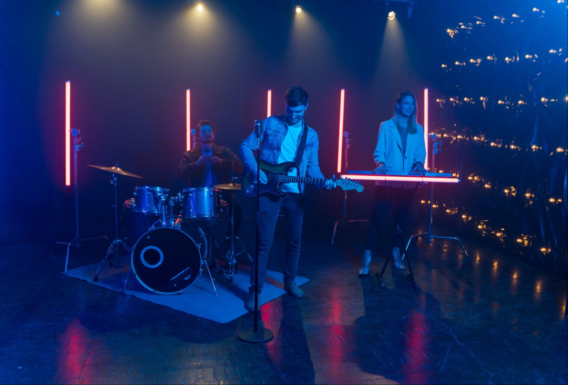 Satellite Motel auf der Bühne: Schlagzeug, Gitarre und Synthesizer im Neonlicht